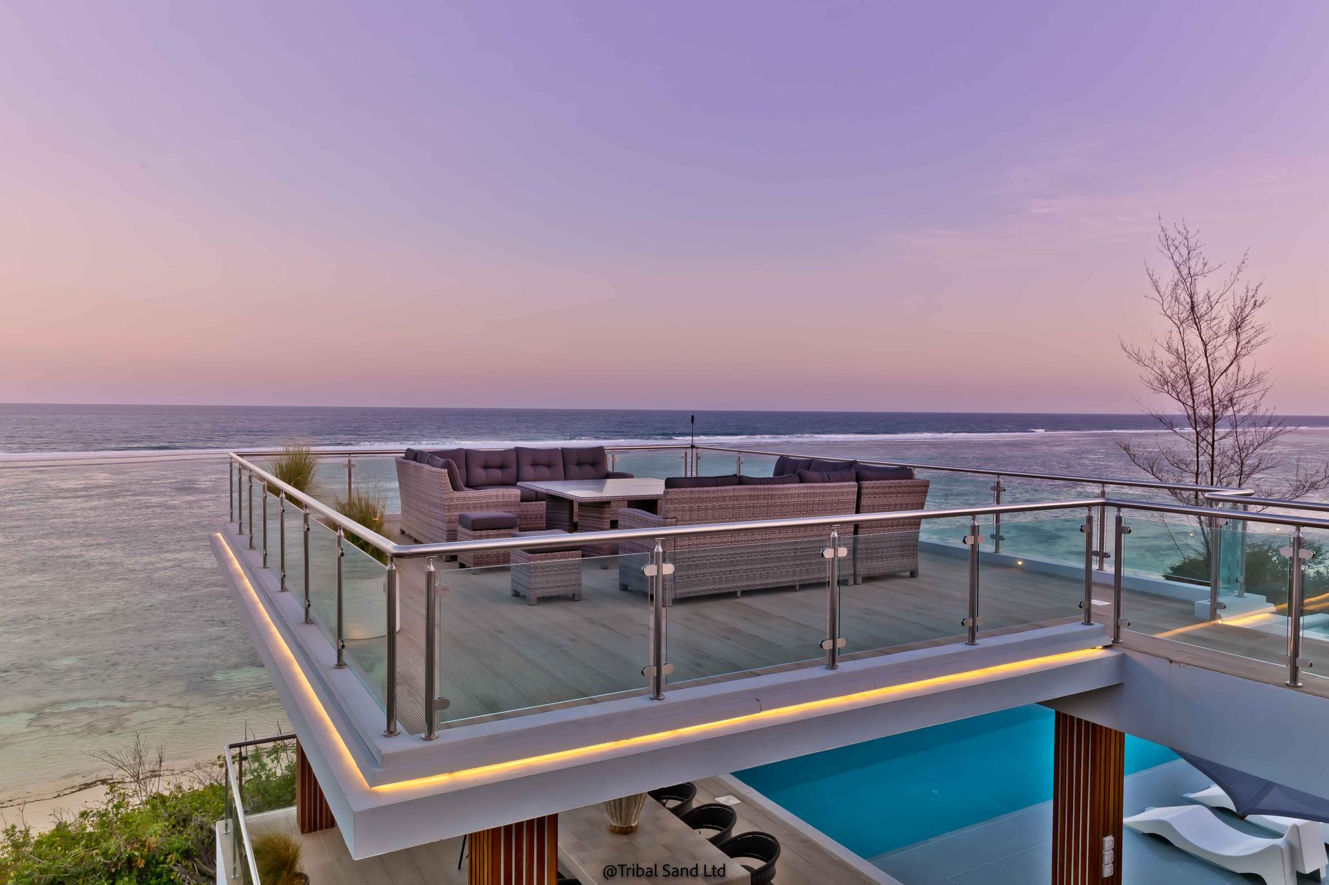 The rooftop deck at My Amani at dusk above the ocean